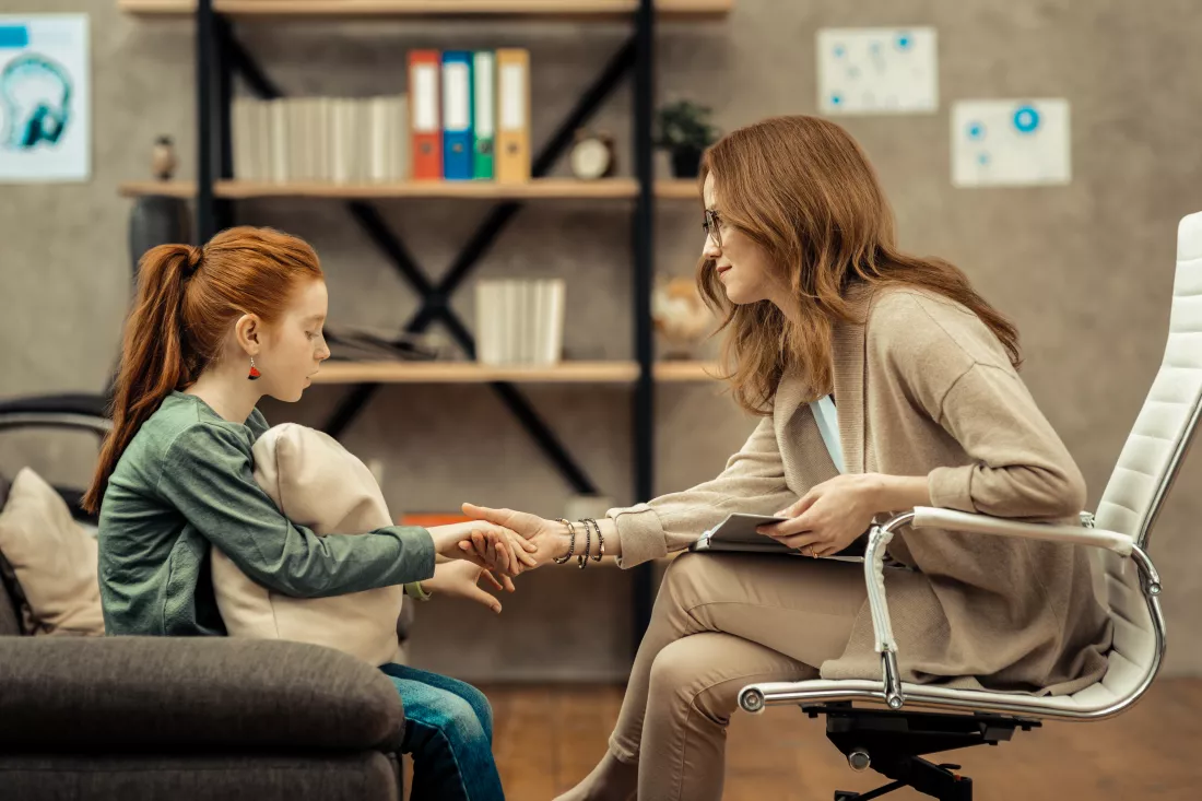 developing-trust-nice-friendly-woman-holding-girls-hand-while-developing-trust-with-her